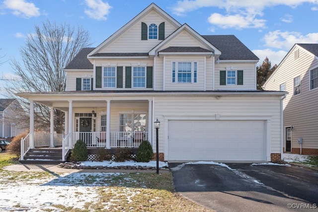 view of front of home featuring covered porch, driveway, and an attached garage