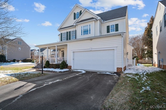 view of front facade with a porch, a garage, and aphalt driveway