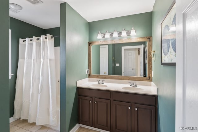 bathroom with double vanity, shower / bathtub combination with curtain, a sink, and tile patterned floors