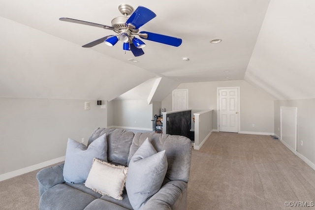 living room with lofted ceiling, baseboards, a ceiling fan, and light colored carpet