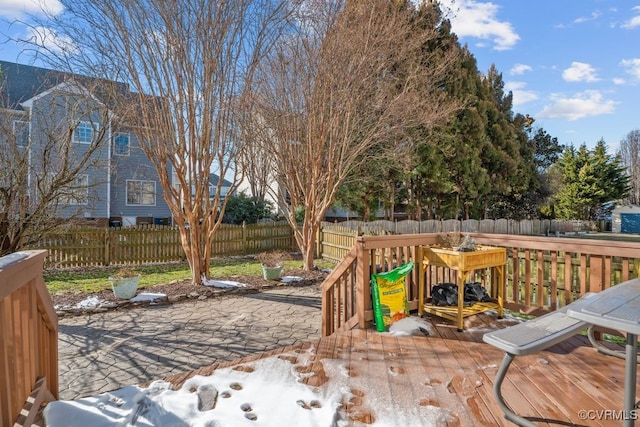 deck with a fenced backyard and a patio