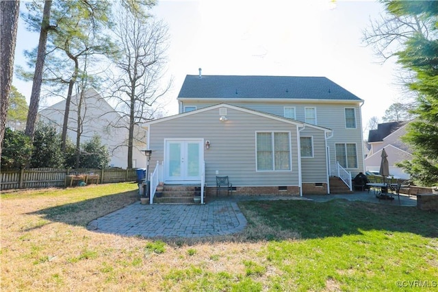 back of property featuring entry steps, a patio area, a lawn, and crawl space