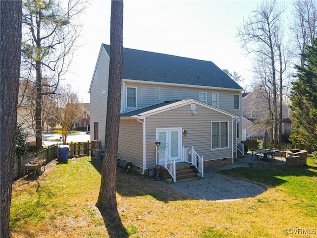 rear view of property featuring a patio area, crawl space, a fenced backyard, and a lawn