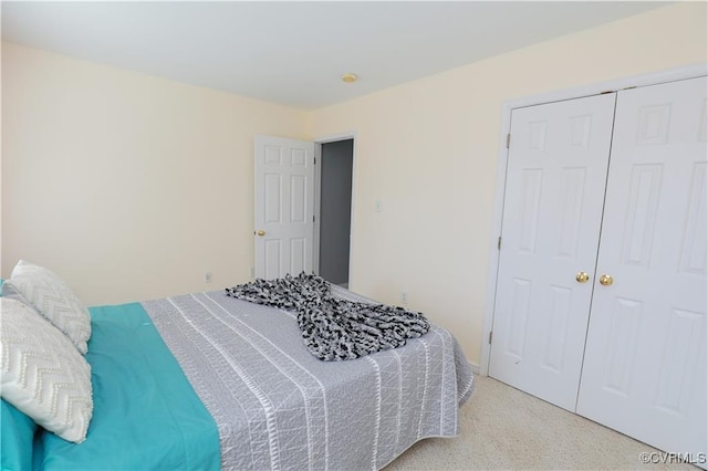 bedroom featuring a closet and light carpet