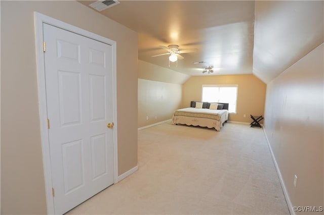 bedroom featuring light colored carpet, a ceiling fan, baseboards, vaulted ceiling, and visible vents