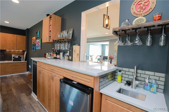 kitchen featuring dark wood finished floors, open shelves, light countertops, hanging light fixtures, and a sink