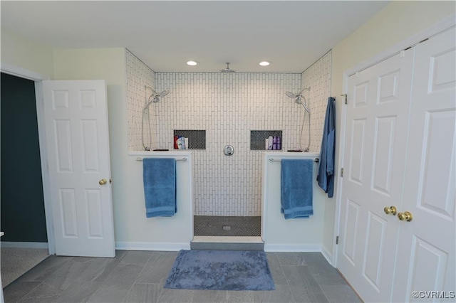 bathroom featuring a walk in shower, baseboards, and recessed lighting