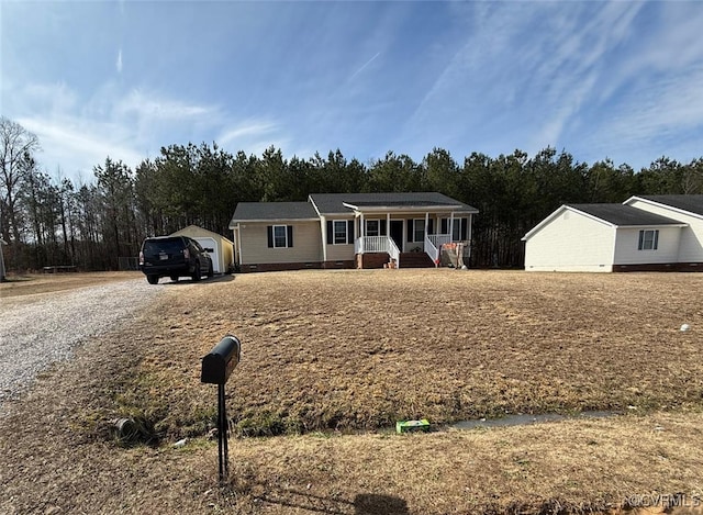 ranch-style home with a porch, crawl space, and driveway