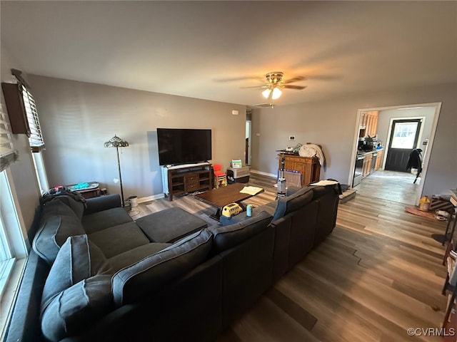 living area featuring a ceiling fan and wood finished floors