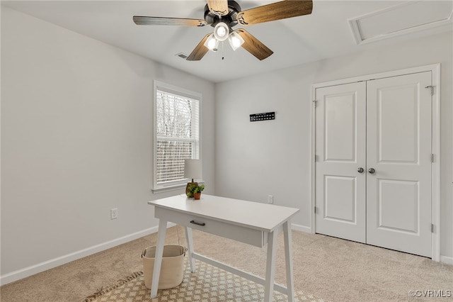 office featuring light carpet, ceiling fan, and baseboards