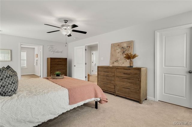 bedroom with light carpet, ceiling fan, and baseboards