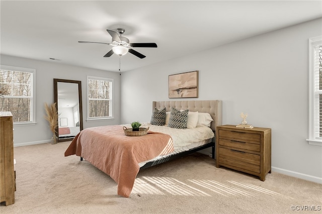 bedroom with light carpet, ceiling fan, and baseboards