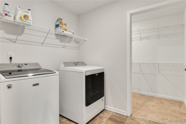 laundry room featuring laundry area, light carpet, washer and clothes dryer, and baseboards