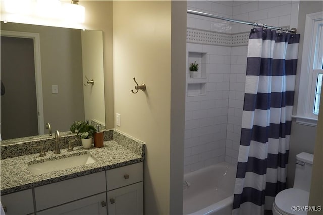 bathroom featuring toilet, vanity, and shower / tub combo with curtain