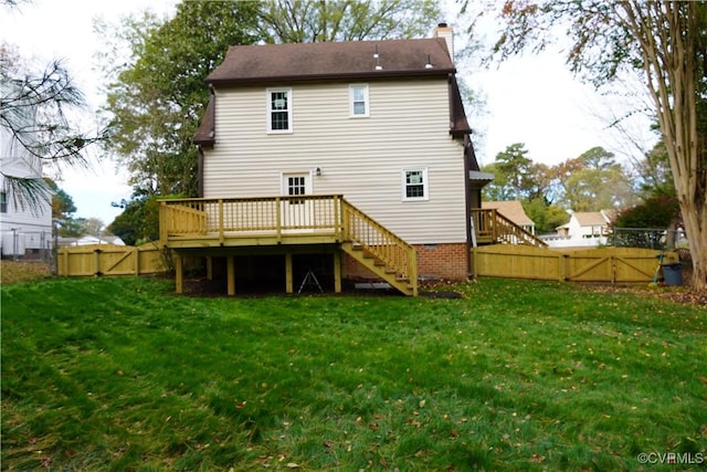 back of house with stairs, a chimney, a fenced backyard, and a gate