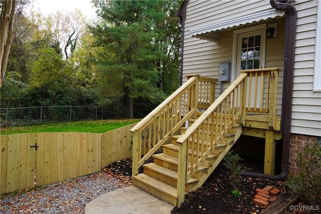 wooden deck featuring stairs and fence