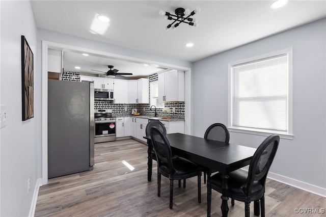 dining area featuring light wood finished floors, recessed lighting, a ceiling fan, and baseboards