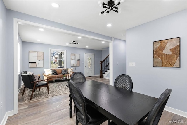 dining space featuring light wood-type flooring, stairs, baseboards, and recessed lighting