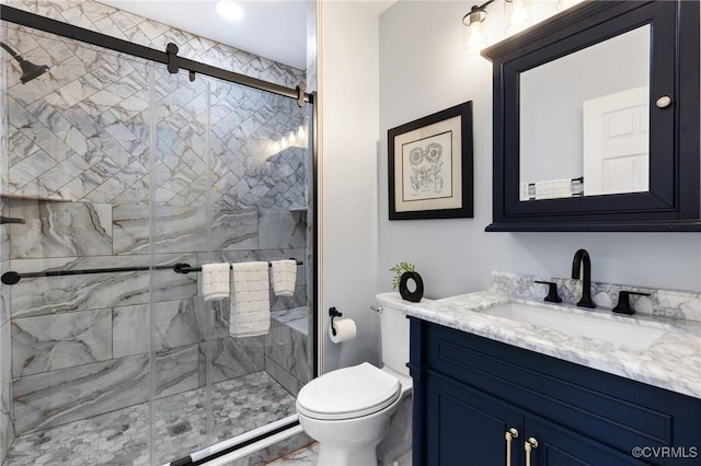 bathroom featuring toilet, a stall shower, and vanity