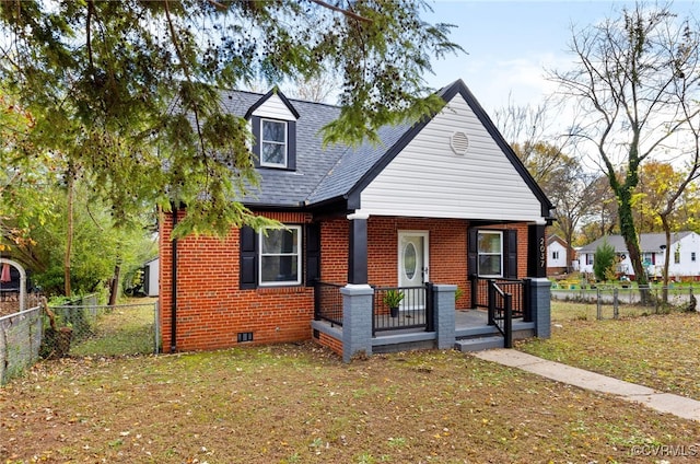 view of front of home with brick siding, crawl space, a front yard, and a fenced backyard