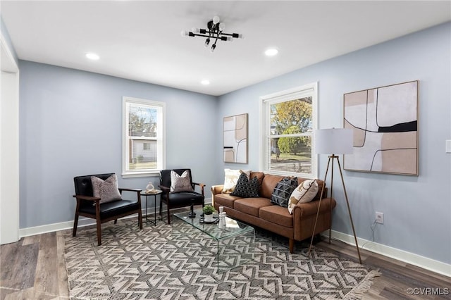 living area featuring baseboards, wood finished floors, and recessed lighting