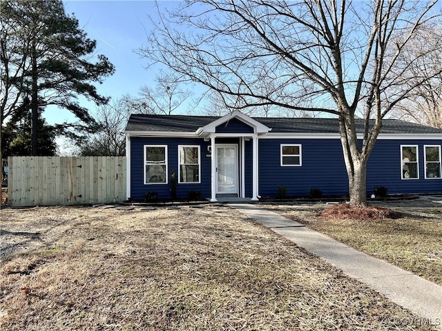 view of front of home featuring fence