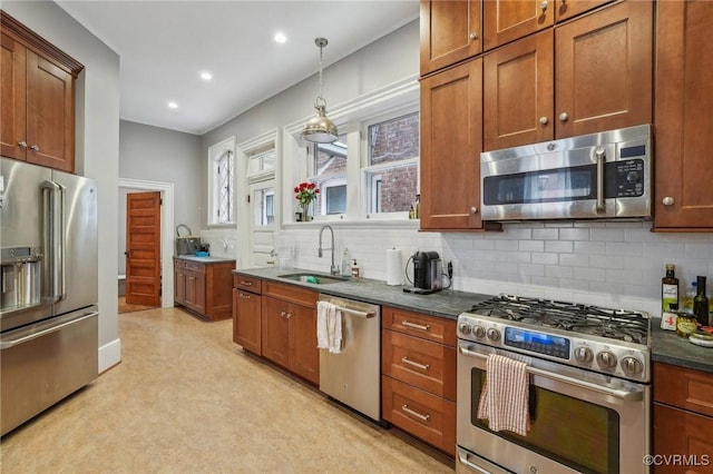 kitchen featuring brown cabinets, stainless steel appliances, and a sink