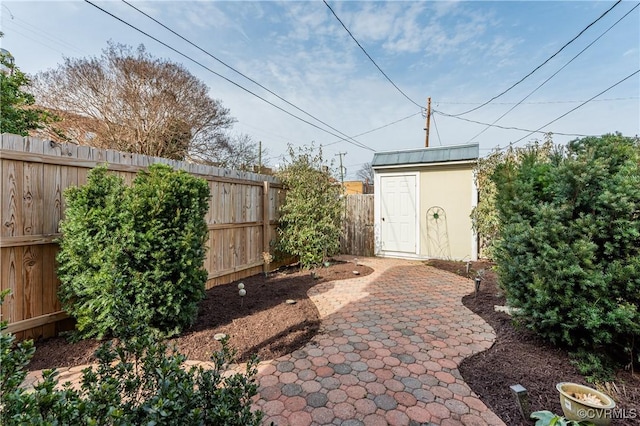 view of patio / terrace with an outdoor structure and a fenced backyard