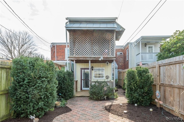 rear view of property with fence