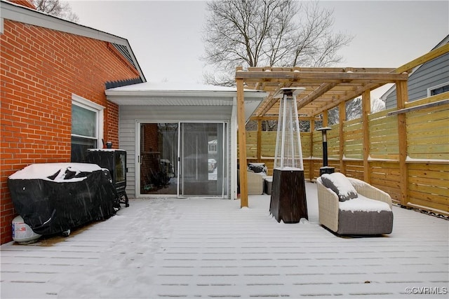 snow covered deck featuring a pergola