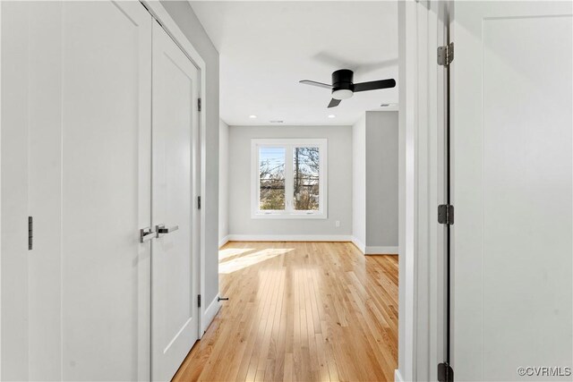 hall with recessed lighting, light wood-style flooring, and baseboards