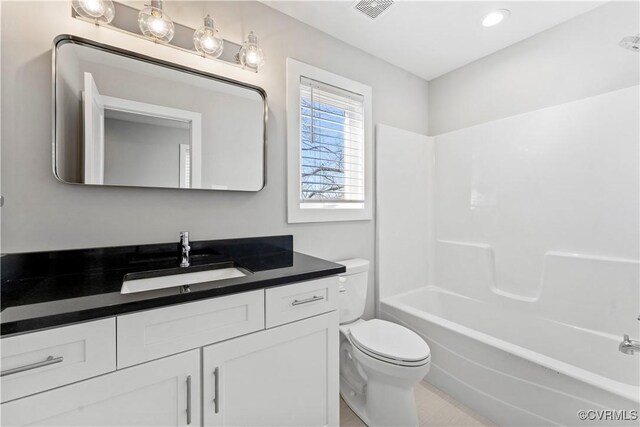 bathroom featuring visible vents, bathing tub / shower combination, toilet, and vanity