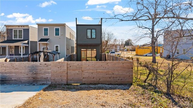 back of property with a fenced front yard