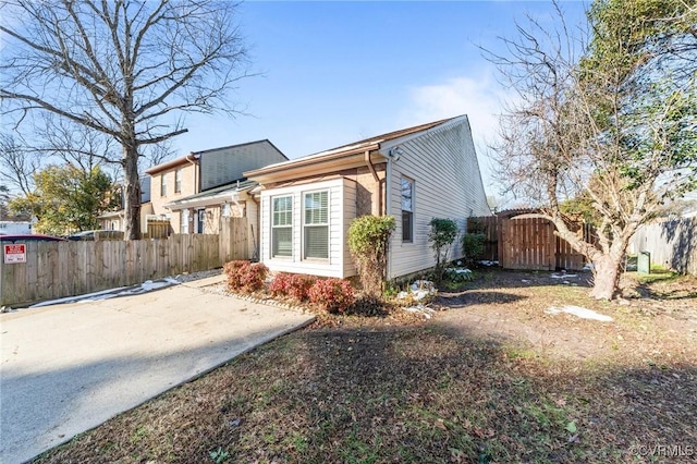 view of side of home featuring fence