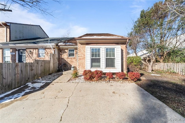 exterior space with brick siding and fence