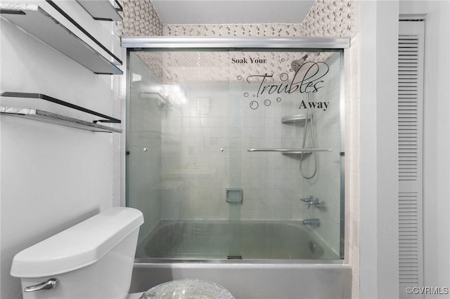 full bath with combined bath / shower with glass door, a closet, and toilet