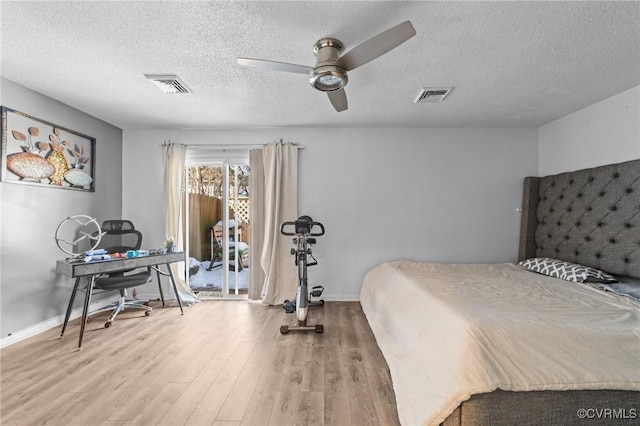 bedroom featuring baseboards, visible vents, and wood finished floors