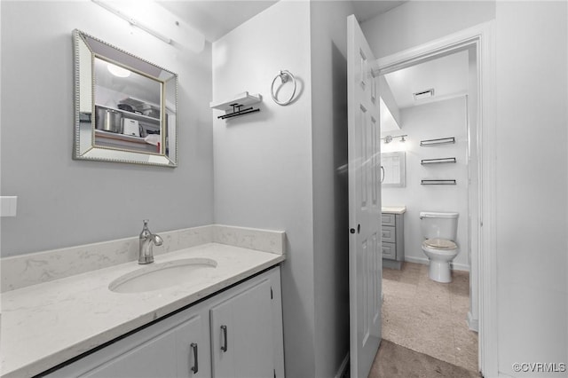 bathroom featuring baseboards, visible vents, vanity, and toilet