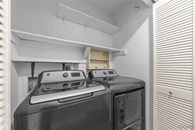 clothes washing area featuring laundry area and washing machine and clothes dryer