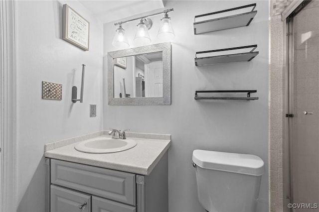 full bathroom featuring an enclosed shower, vanity, and toilet