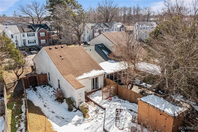 snowy aerial view with a residential view