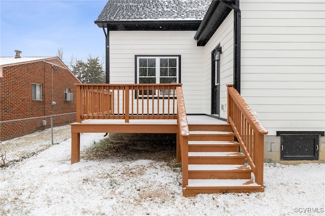 snow covered deck with fence