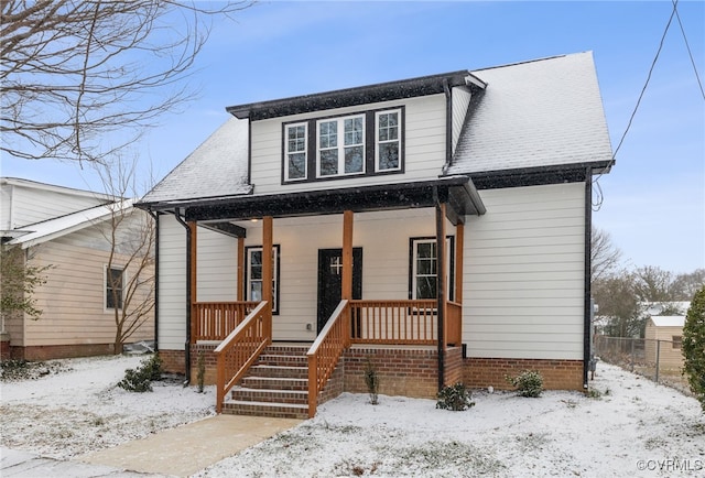 bungalow-style home with a porch, roof with shingles, and fence