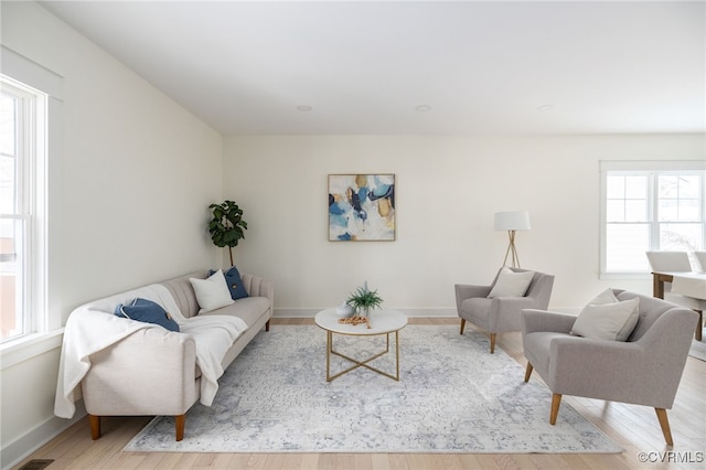 living room featuring light wood-style flooring and baseboards