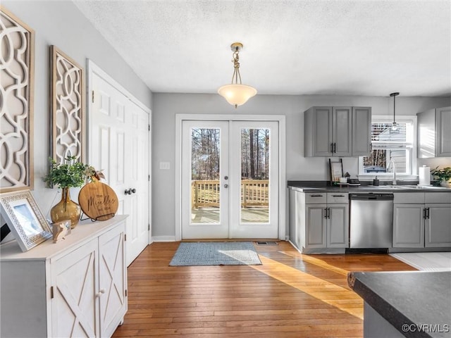 doorway featuring french doors, visible vents, a textured ceiling, and light wood finished floors