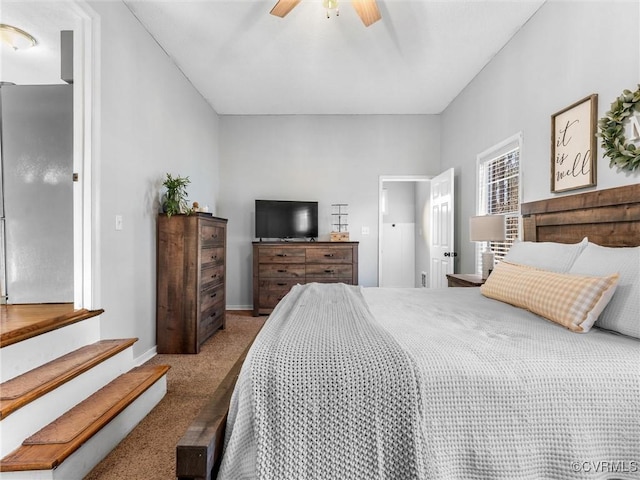 bedroom with light carpet, ceiling fan, and baseboards