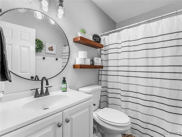 bathroom featuring vanity and toilet