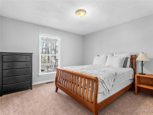 bedroom featuring carpet floors, visible vents, and baseboards