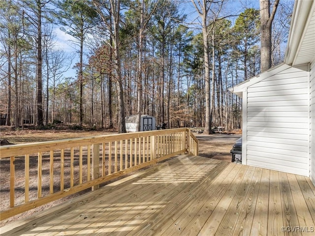 wooden deck featuring a storage unit and an outdoor structure