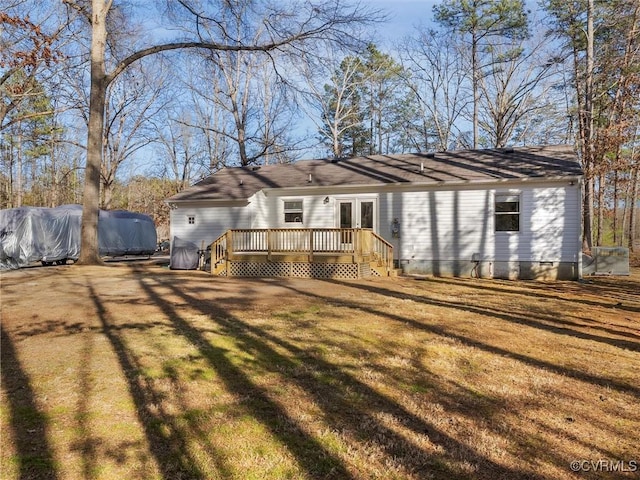 back of property with crawl space, a deck, and a yard